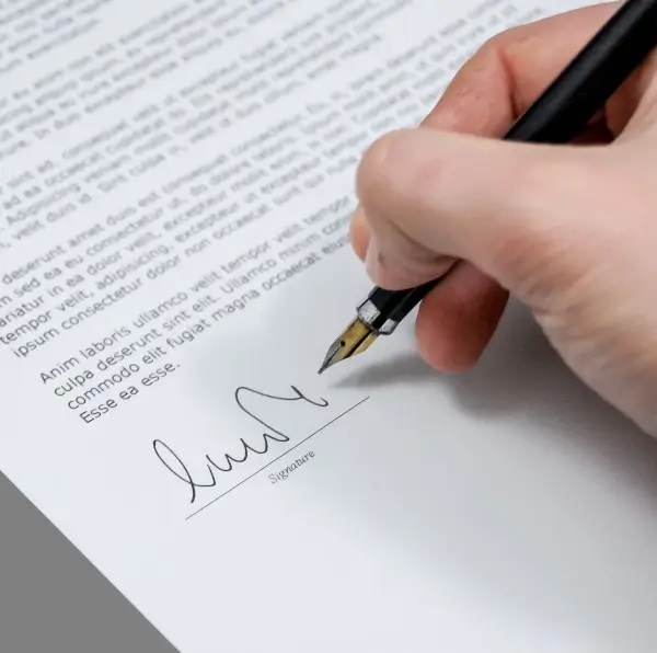 A person signing a cover letter